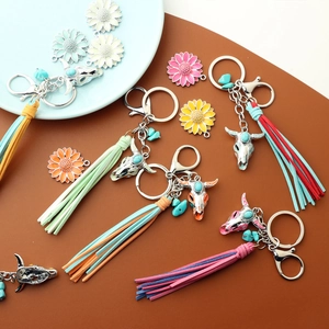 Detail of western cow skull keychain with colorful tassels and turquoise flower charms