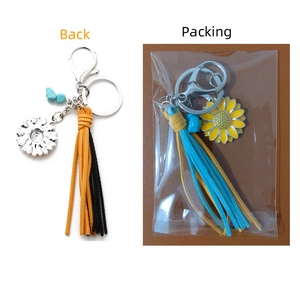 Detail of vintage Western sunflower keychain with leather tassels and turquoise stone bead