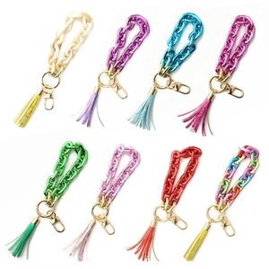 Set of eight colorful acrylic chain keychains with tassels and gold metal hardware