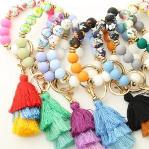 Detail of colorful silicone beaded keychain bracelets with decorative layered tassels