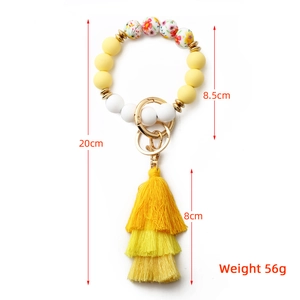 Bohemian floral silicone bead bracelet keychain with yellow tassel and gold clasp detail