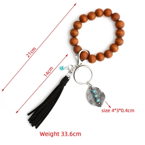 Bohemian wood bead keychain bracelet with black leather tassel and alloy leaf pendant