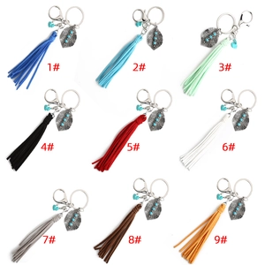Detail view of 9 vintage bohemian leaf keychains with colorful tassels and turquoise beads