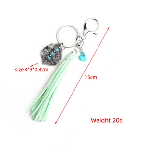 Detail view of Bohemian leaf keychain with turquoise beads and a long mint green tassel