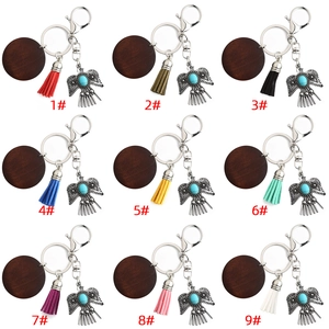 Macro view of nine bohemian leather tassel keychains with eagle pendants and turquoise