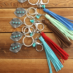 Bohemian leaf keychain with turquoise stone and colorful suede tassels on wood