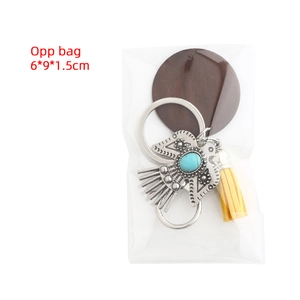 Detail of bohemian eagle keychain with blue turquoise and yellow tassel in OPP bag