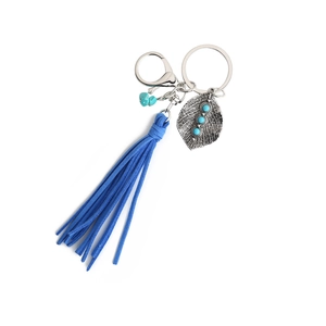 Detail of bohemian turquoise leaf keychain with blue suede tassel and silver alloy clasp