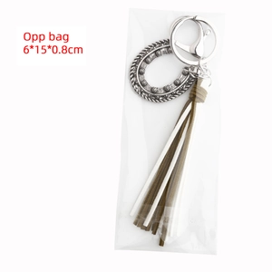 Detail of bohemian horseshoe keychain with tassels in OPP bag packaging 6x15x0.8cm