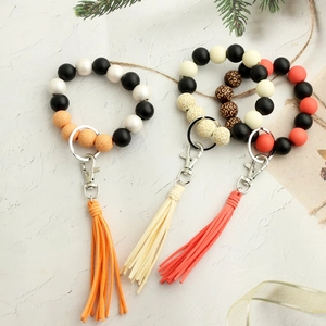 Bracciale portachiavi retrò in perle di legno con nappa in pelle e chiusura in metallo