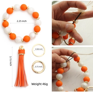 Silicone bead wristlet keychain with orange leather tassel and gold metal spring clasp