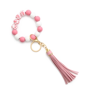 Bracelet porte-clés en silicone rose et blanc avec boucle dorée et pompon en cuir