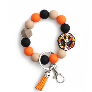 Porte-clés en perles de silicone avec pendentif floral et gland orange élégant