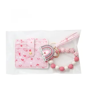 Detail of pink heart PU card holder with beaded wristlet and Valentine's Day charm