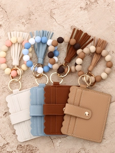 Detail view of silicone bead bracelets with PU tassel wallets and leather card slots