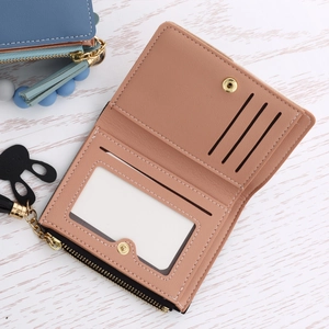 Macro view of short bifold leather wallet with card slots and a metal zipper pocket