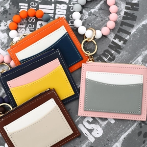 Detail of colorful silicone bead wristbands and PU leather card holder wallets with zippers
