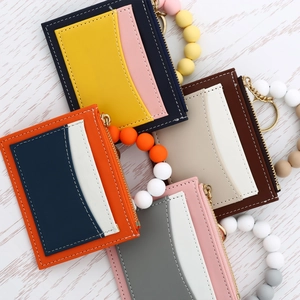 Close-up of colorful PU leather card wallets with macaron silicone bead wristlets and zippers