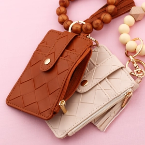 Detailed view of woven PU leather card holders with beaded wristlets and gold zippers