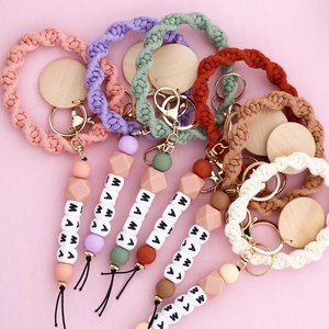 Detail view of woven MAMA beaded keychains with silicone beads and golden metal ring