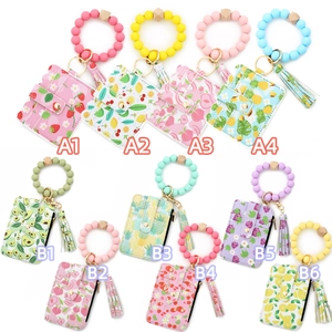Detail view of colorful silicone beaded bracelets with patterned card holder wallets