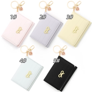 Detailed view of five colorful bowknot wallets with pearl heart keychains