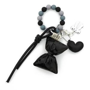 Silicone bead keychain with black leather heart, puffy bow and metal charms