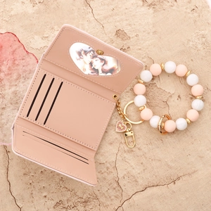 Pink PU leather bifold wallet with silicone beaded heart bracelet keychain set
