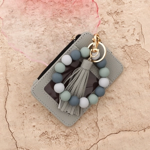Gray faux leather card wallet with silicone beaded wristlet and leather tassel keyring