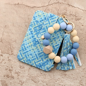 Silicone bead keychain with blue pixel plaid card holder and tassel on stone background