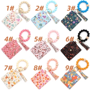 Close-up of PU leather card holder sets with beaded silicone wristbands and floral prints