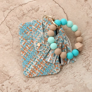 Macro detail of tricolor woven wallet keychain with silicone bead wristlet strap