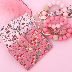 Detail of mushroom print card wallet with silicone beads and matching leather tassel