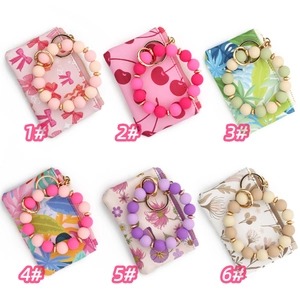 Collection of six mini zipper wallets with matching silicone bead wristbands and keyrings