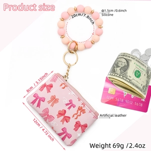 Pink bow wristlet wallet detail with silicone bead bracelet and gold ring clip