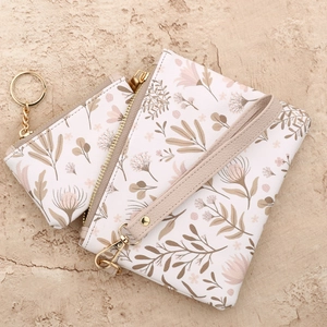 Set van leren polstasje en portemonnee met bloemenprint en goudkleurige details