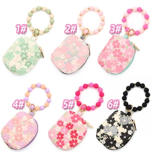 Detailed grid of six floral waterproof wristlet wallets with silicone bead keychains