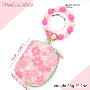 Detailed size specifications of pink floral coin purse with silicone beaded wristlet strap