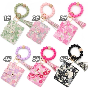Six sets of floral card holder keychains with colorful silicone bead wristbands and tassels
