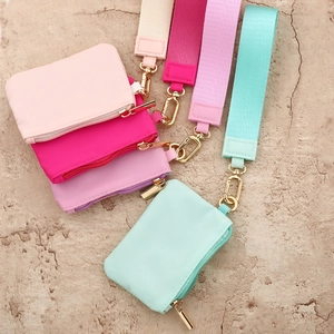 Mini nylon wristlet wallets in macaron colors with gold hardware and fabric strap