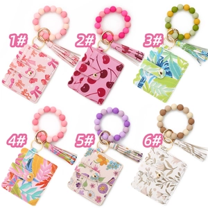 Multiple silicone bead wristlet keychain sets with floral card wallets in a grid display