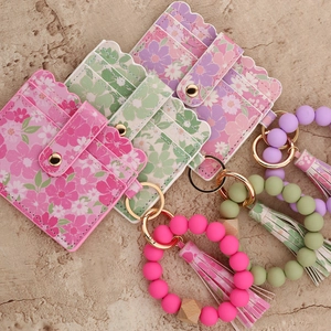 Detail view of floral card holder keychain sets with silicone bead wristlets and tassels