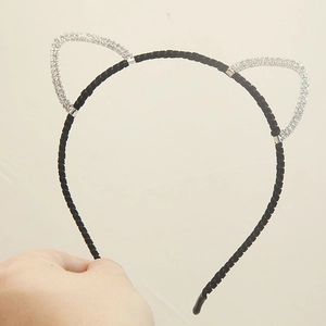 Detail shot of a cute cat ear headband featuring silver crystal rhinestones and a black band
