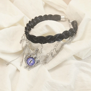 Gothic Leder-Choker mit silbernen Ketten und lila bösem Blick Anhänger auf weißem Stoff