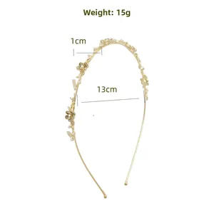Détail du serre-tête doré avec fleurs en œil de chat et indications de poids de 15g