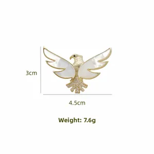 Macro shot of eagle brooch with mother of pearl wings, measuring 4.5cm by 3cm