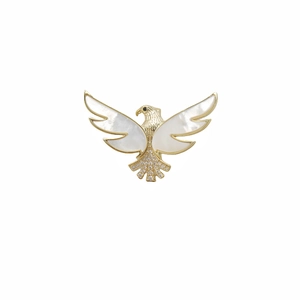 Elegant gold eagle brooch with natural shell wings and sparkling crystal accents on white