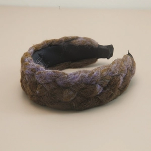 Detail of the chunky braided headband featuring a woven pattern in purple and brown hues