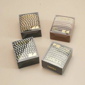 Detailed set of four elastic hair tie gift boxes with diverse woven color patterns