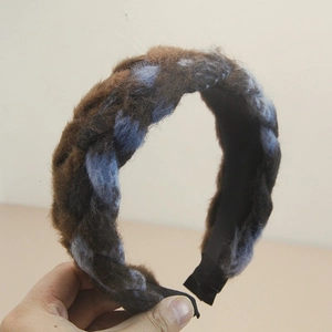 Close-up of brown and blue plush braided headband with thick Bohemian twist texture